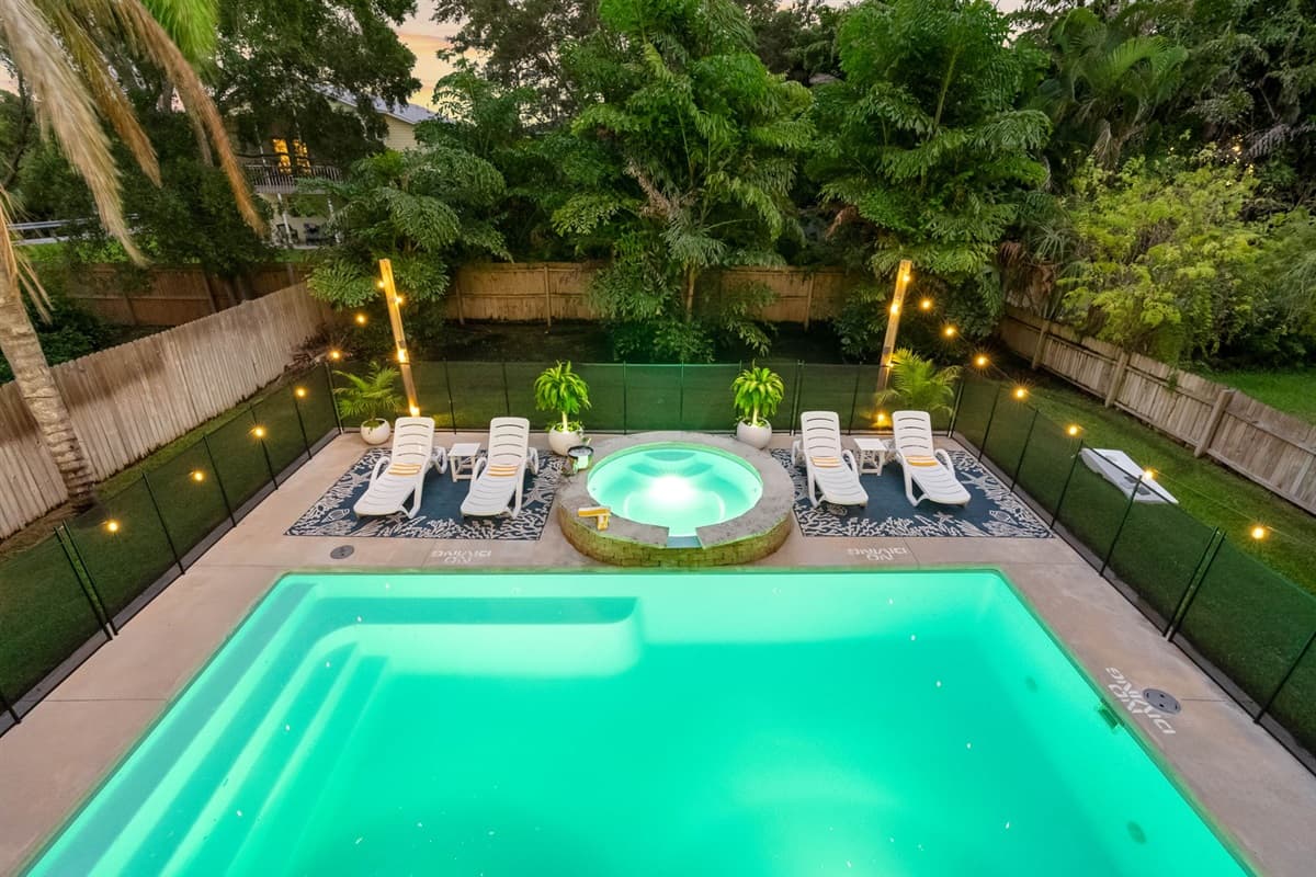 Perfect for your next vacation, this backyard features a sparkling pool, fenced yard, and upper deck with space to relax and recharge.