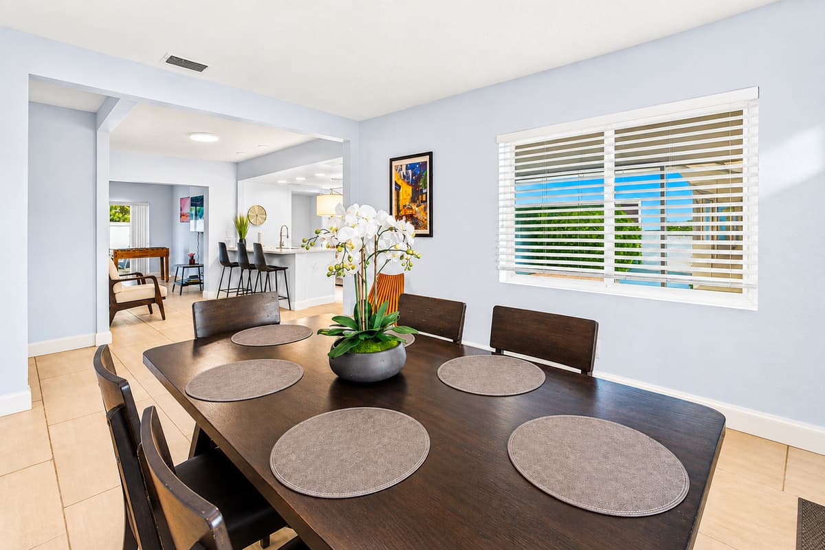 Spacious dining room with large windows, ample seating, and a welcoming atmosphere for gatherings.