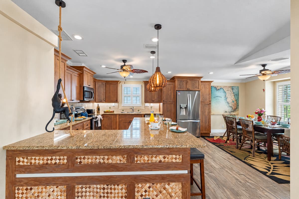 Designed for both beauty and practicality, the kitchen features warm cabinetry, granite surfaces, and everything needed to feel at home.