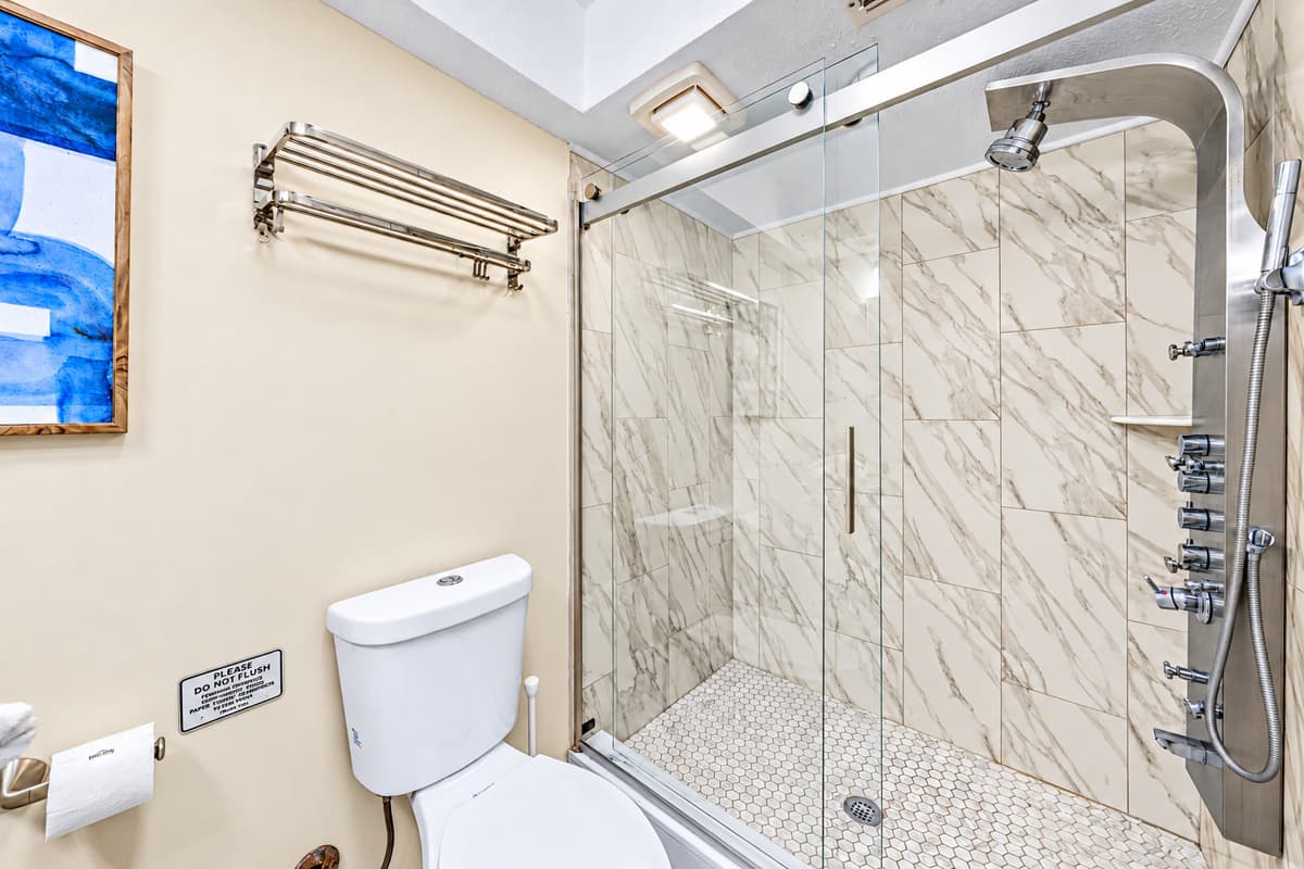 Elegant bathroom with a spacious vanity and beautifully tiled walk-in shower.