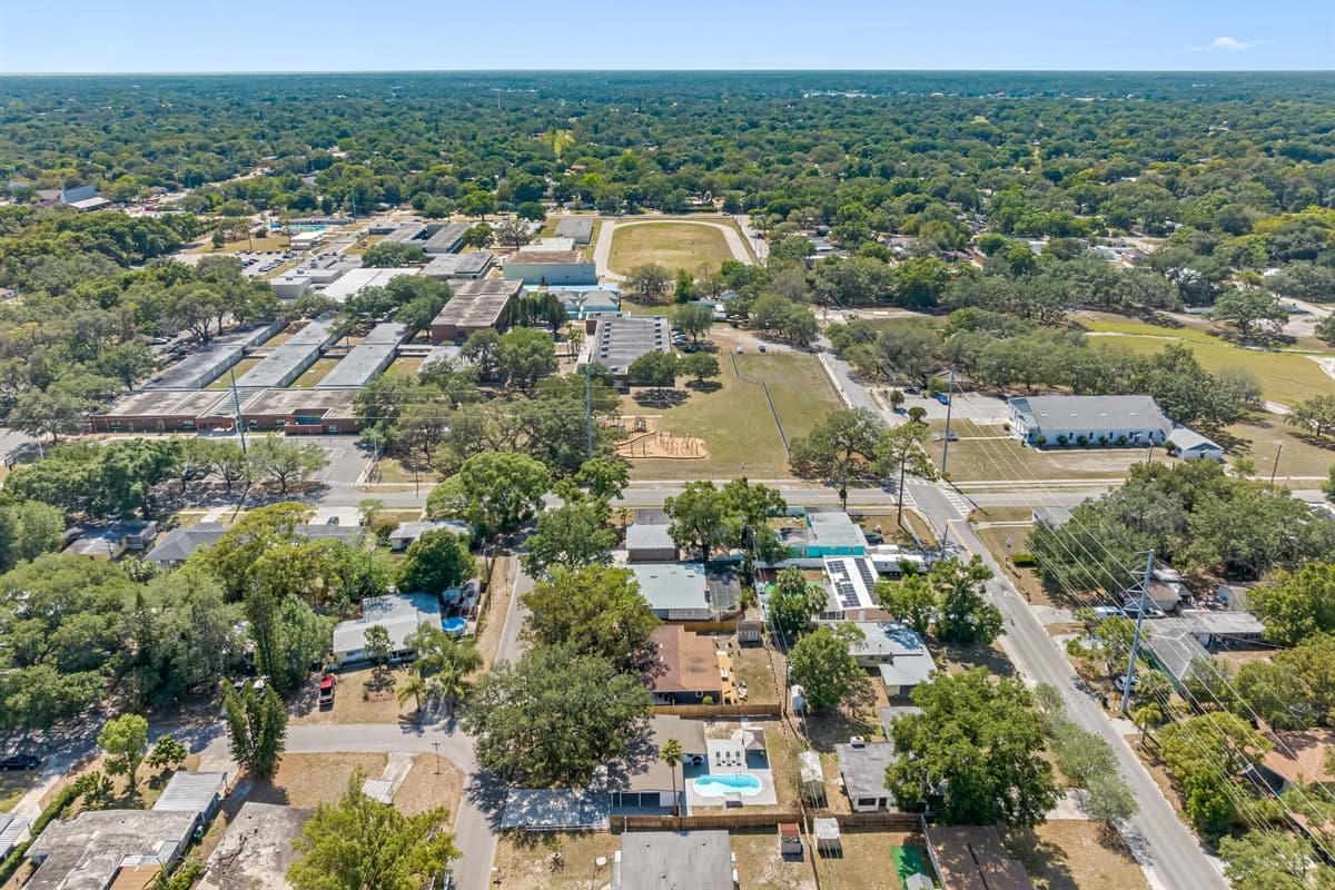 Beyond the property, the charming neighborhood unfolds, with winding roads and leafy