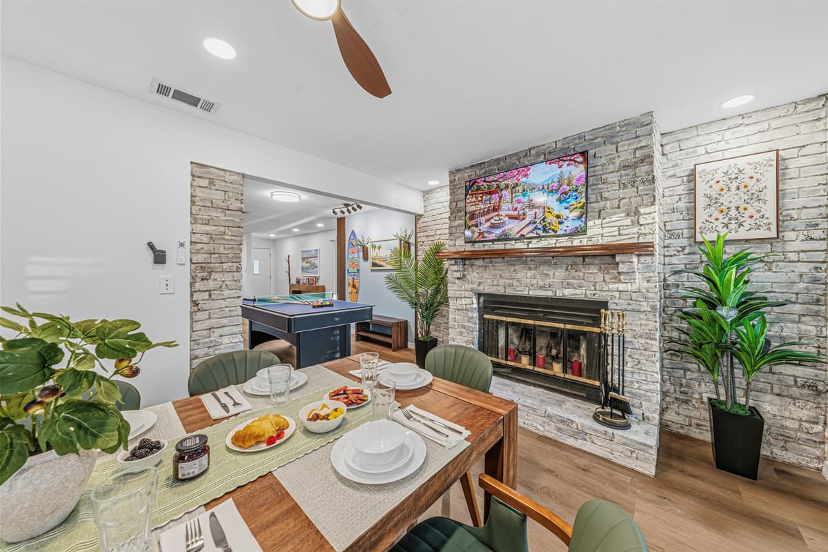 Elegant dining setup with fireplace backdrop—ideal for shared meals and memorable moments 
Table settings and food are for staging purposes only and are not included.
