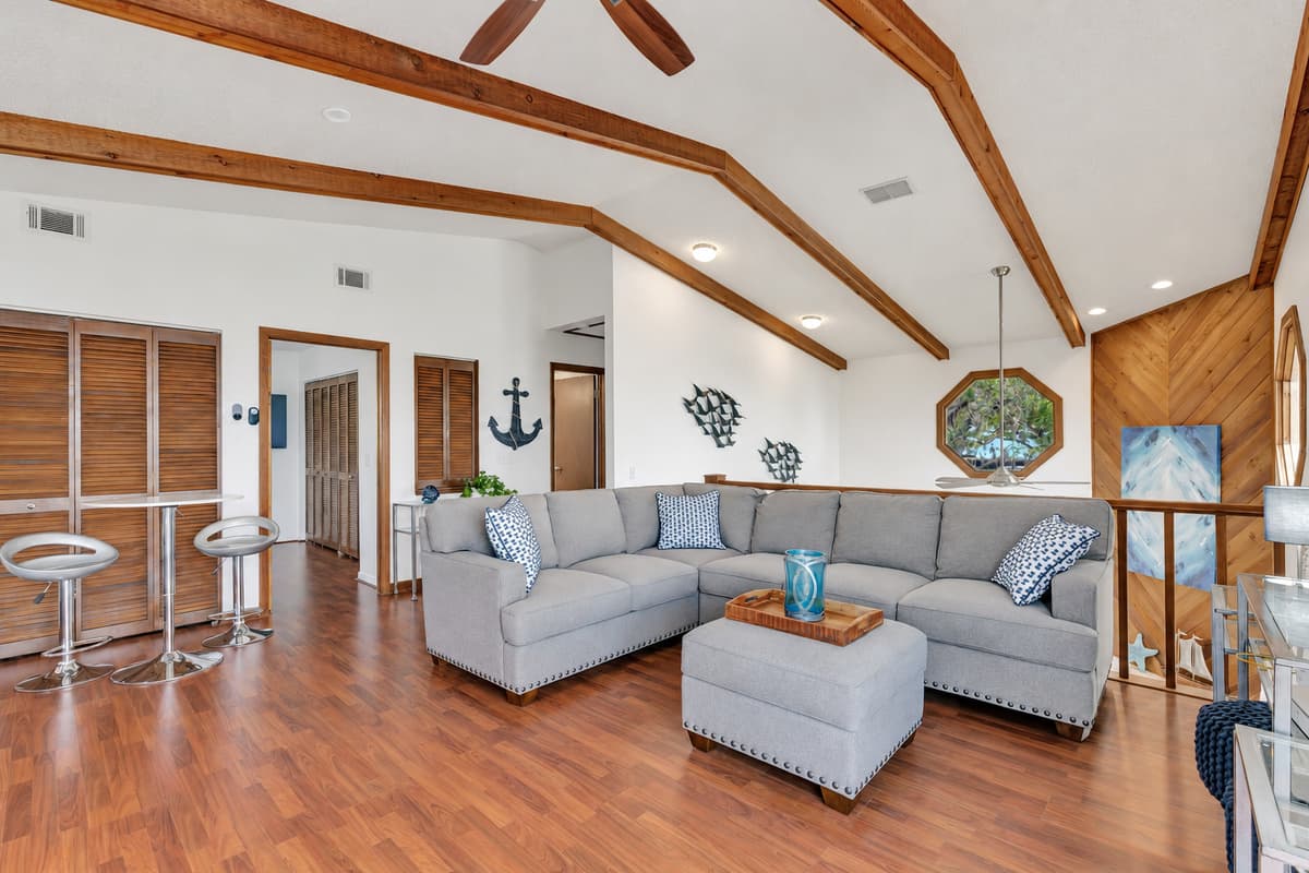 Adjacent to the day bed, a cozy couch awaits, offering ample seating for you and your guests to gather and share moments of laughter and connection.