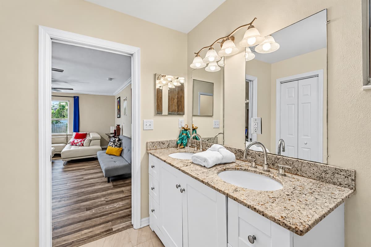 Bright bathroom with large vanity and easy access to adjacent living spaces.