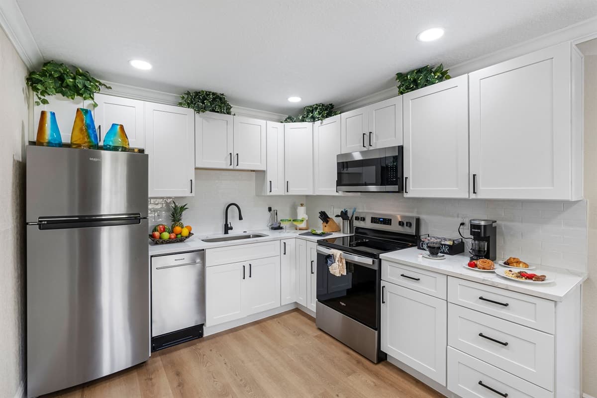 The layout is open and user-friendly, allowing you to move easily between the refrigerator, stove, and prep areas while staying connected to guests in the adjacent dining and living rooms.