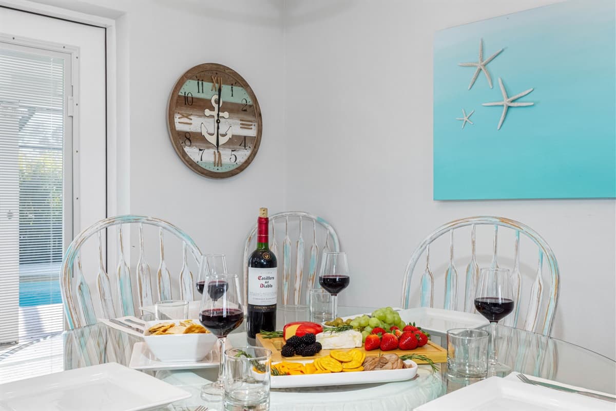 Positioned under a stylish light fixture, this space creates an inviting atmosphere for shared meals and meaningful conversations.
