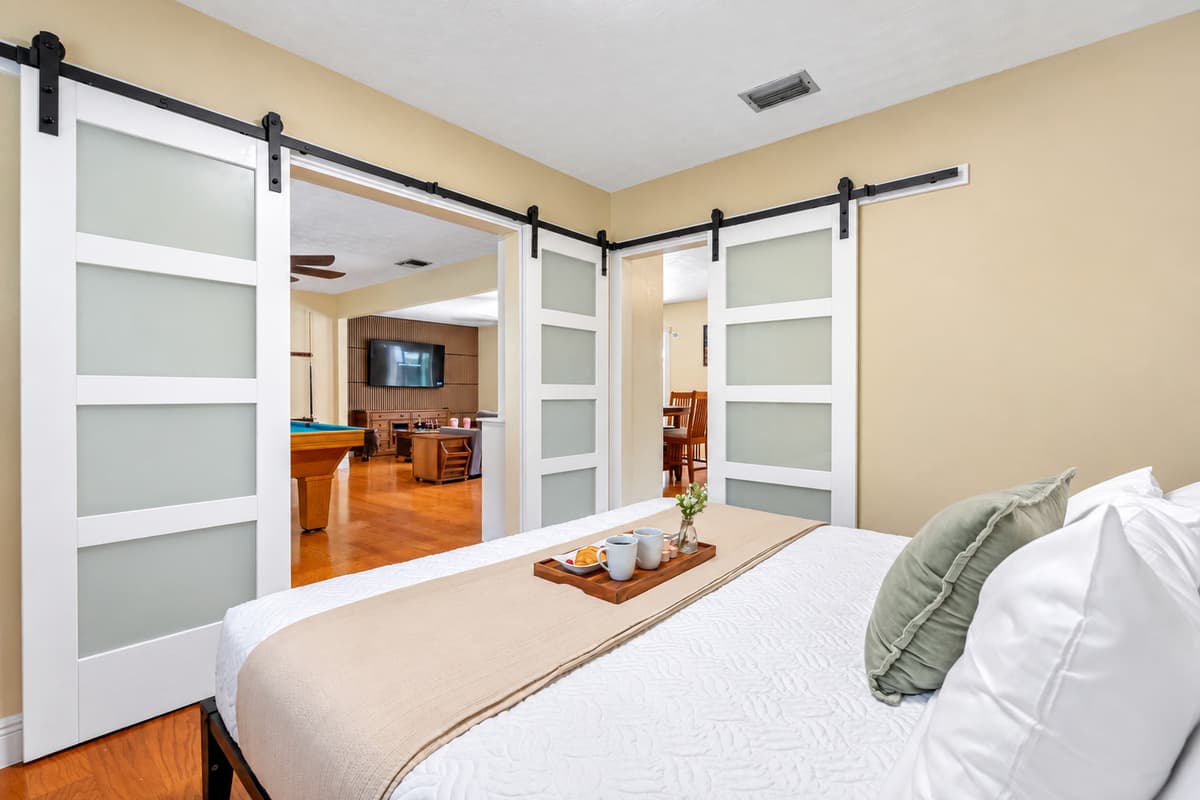 Bright and cozy king bedroom featuring soft linens and calming décor.
