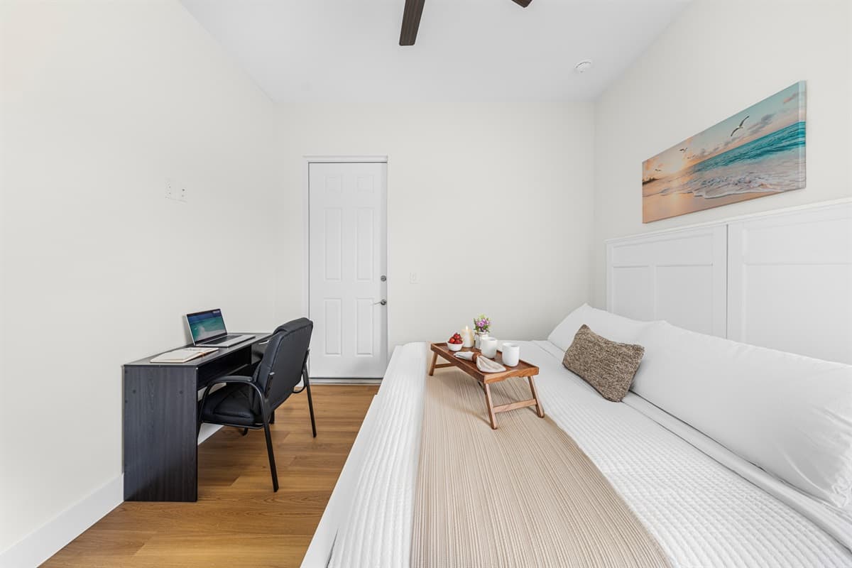 Spacious bedroom with desk setup—ideal for both relaxation and productivity.