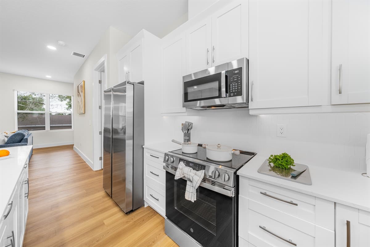 Wake up refreshed in crisp white linens with a cozy throw blanket. Every bedroom has its own ceiling fan and natural light.