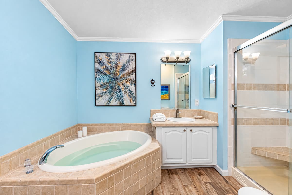 Unwind in the large soaking tub, beautifully framed by soft tilework, or refresh in the walk-in glass shower with built-in seating for added comfort.