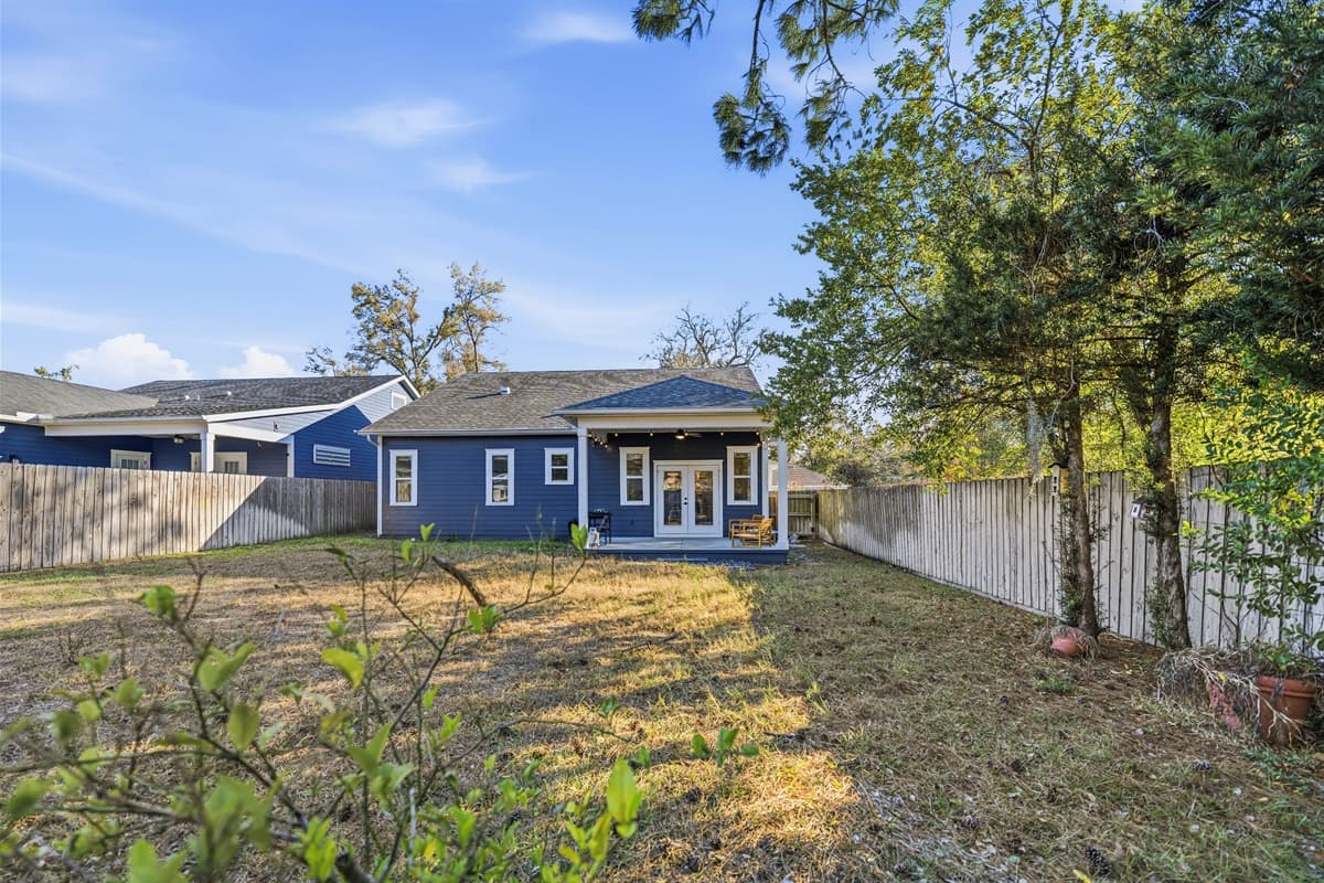 Room to breathe! The spacious fully fenced backyard of this brand-new Seminole Heights home offers a large grassy area, mature shade trees, and total privacy — perfect for gatherings, lawn games, or simply enjoying the Florida sunshine.