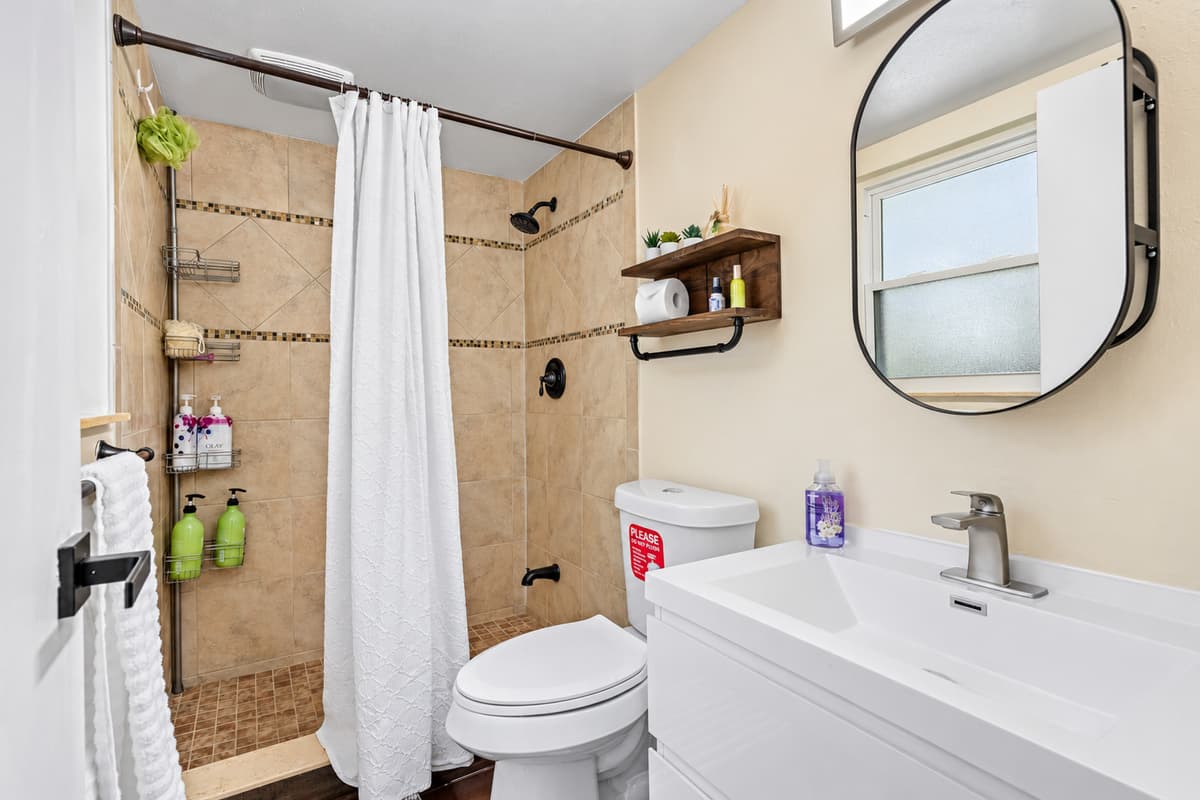 As you step into this stunning bathroom, you're immediately struck by the sleek and modern design. 