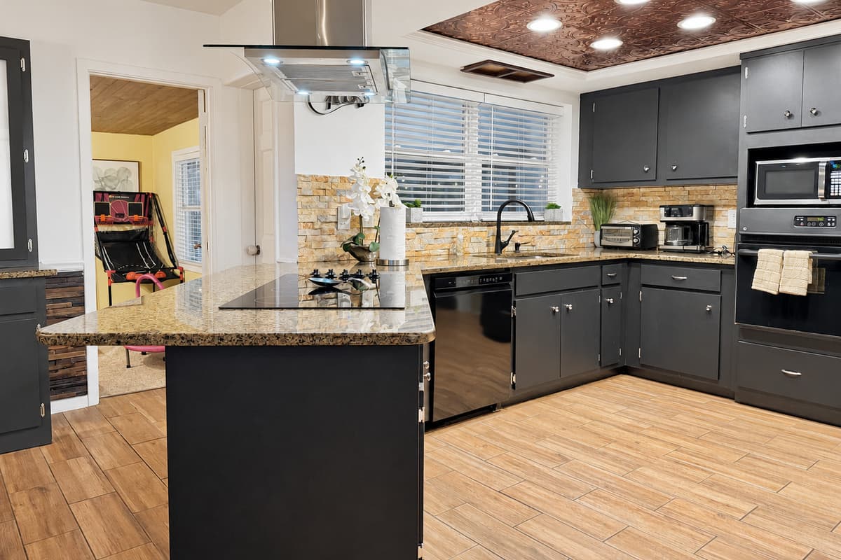 Spacious, modern kitchen featuring sleek cabinetry and ample counter space.