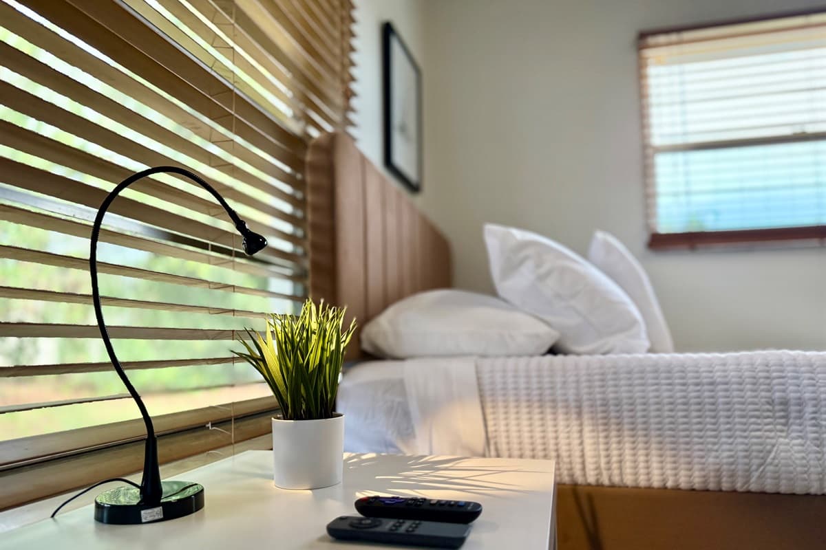 A neutral color scheme, soft linens, and blackout shades make this room a true rest haven. 