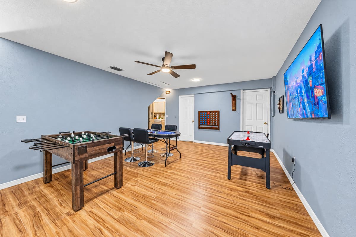Full game lounge with multiple activities including foosball, arcade-style fun, and big-screen TV 