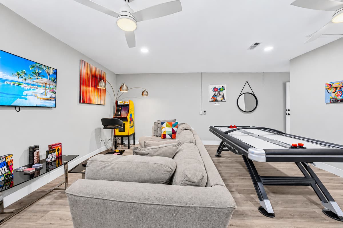 Gather with family and friends in the game room featuring air hockey and a large sectional.