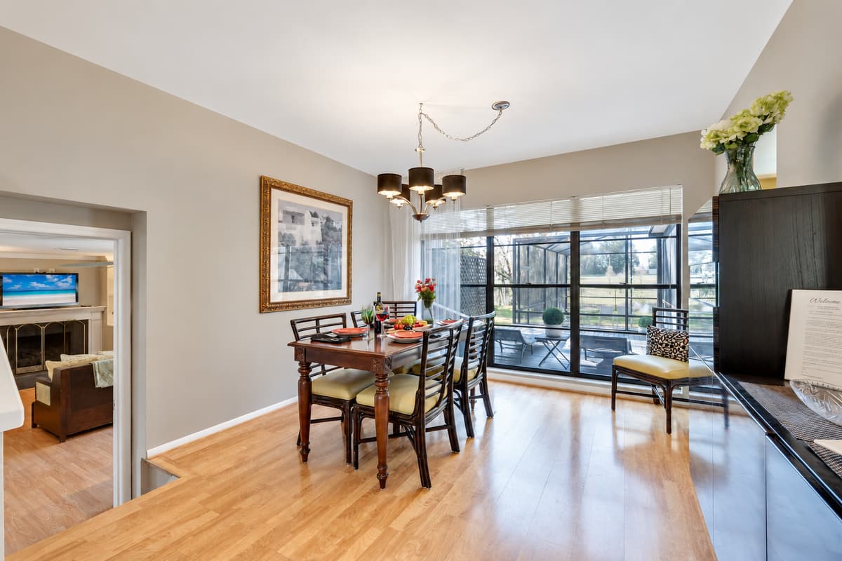 As you gather around the table, bask in the warmth of the sun's gentle rays cascading through the expansive window.