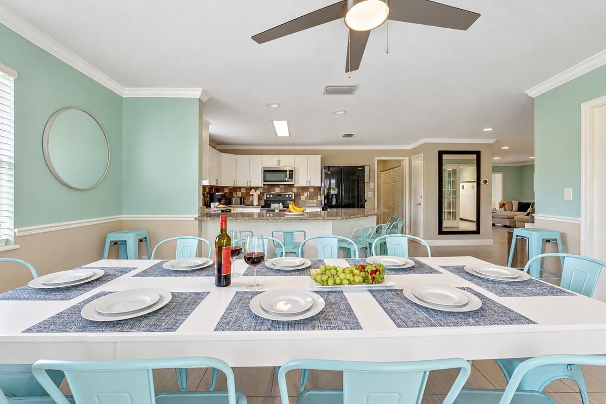 Gather around the inviting dining table, surrounded by a collection of comfortable chairs.