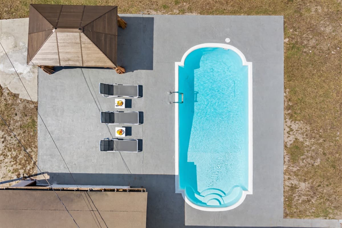 As you soar over the property, you'll see the crystal clear waters of the pool shimmering in the sunlight.