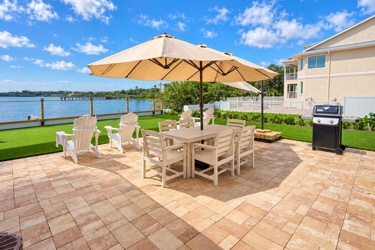 Waterfront patio with outdoor dining and places to relax.