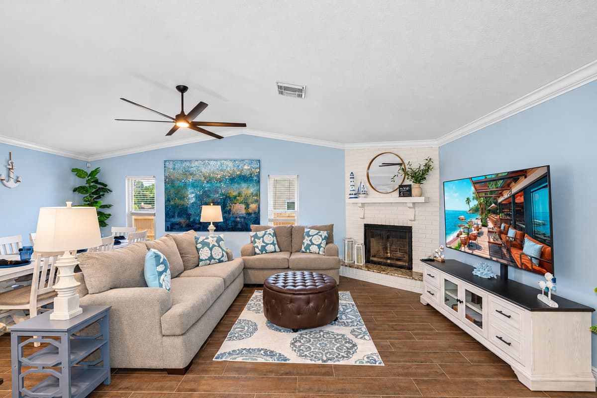 The seating arrangement is thoughtfully arranged to foster conversation and comfort, with each couch adorned in high-quality fabrics that blend seamlessly with the room's decor.