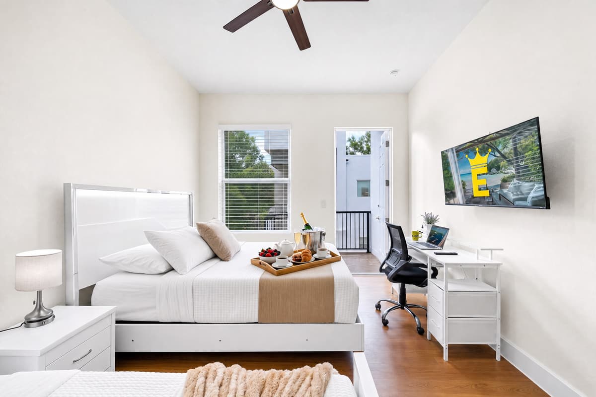 Your own private suite with a queen bed, twin bed, wall-mounted Smart TV, and a full work desk. Sleep, stream, or work — your call.