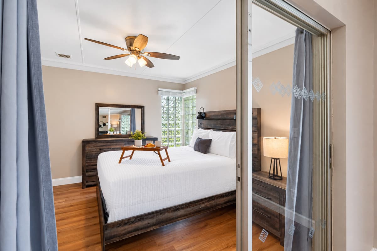 Large windows and glass accents allow plenty of natural light to flow in, giving the room a bright and refreshing feel.