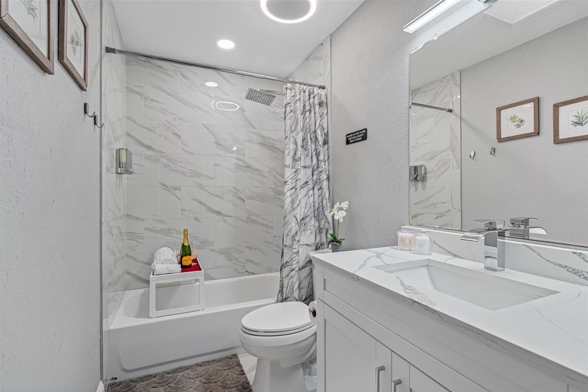 Beautiful bathroom equipped with sink, toilet, and a bathtub and shower combo. Enjoy a relaxing bath after a long day of travel from your home to your home away from home. If you think this property is for you, send us an inquiry right away!