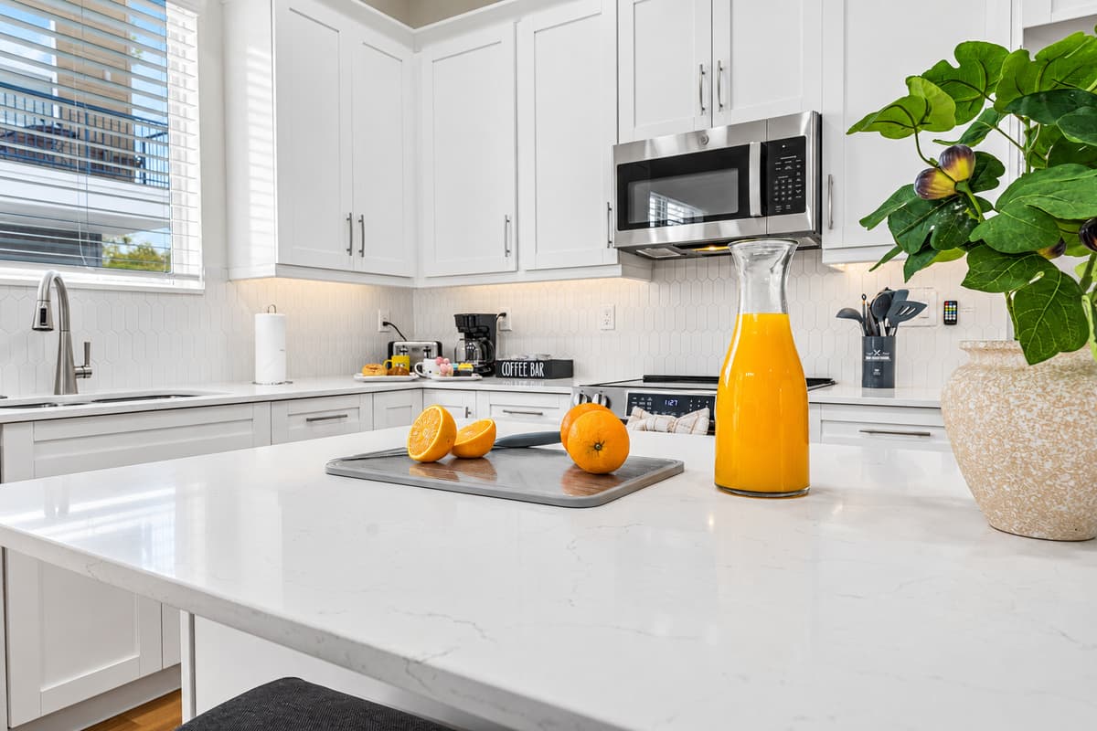 Clean and modern kitchen design with natural light and stylish finishes throughout.