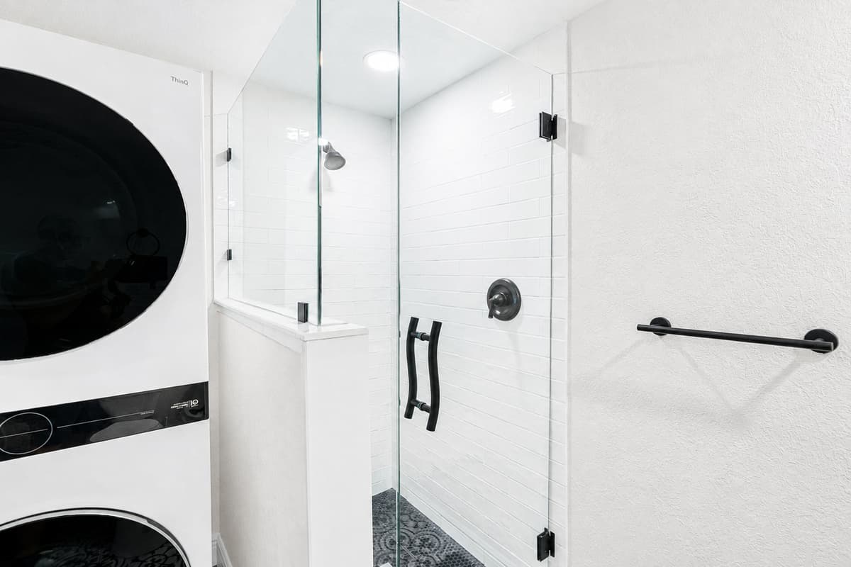 The sleek, frameless glass shower enclosure adds a modern touch while keeping the space open and airy.