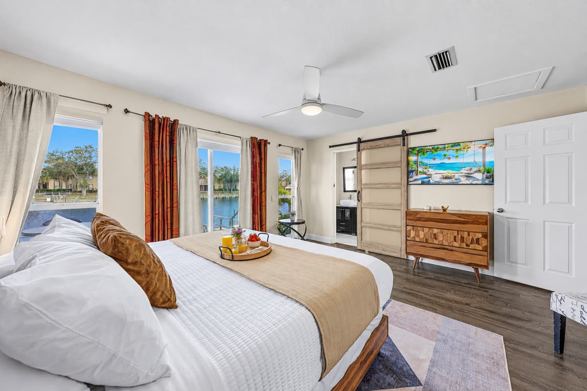 Relax in the oversized primary suite with Smart TV, king bed, and direct patio access.