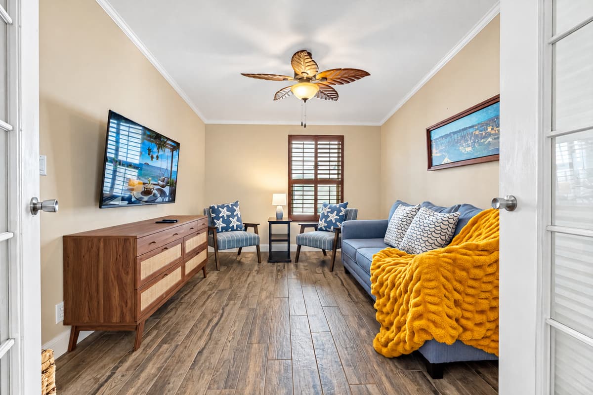 Featuring a comfortable sofa and two charming starfish-accented chairs, this serene space is ideal for relaxation, reading, or quiet conversation.