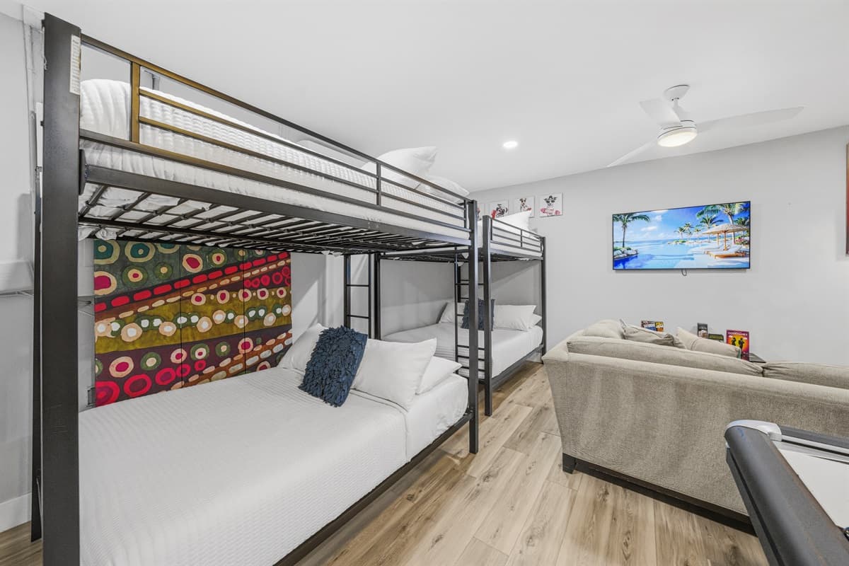 Bunk beds offer comfortable sleeping accommodations right next to the entertainment area.