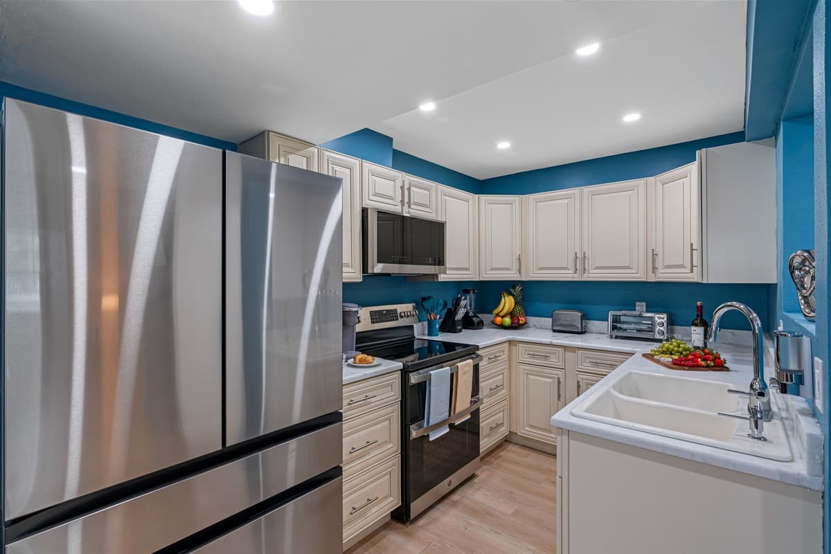 As you step into this captivating space, your eyes are immediately drawn to the enormous fridge, standing tall and proud, ready to store your culinary treasures.