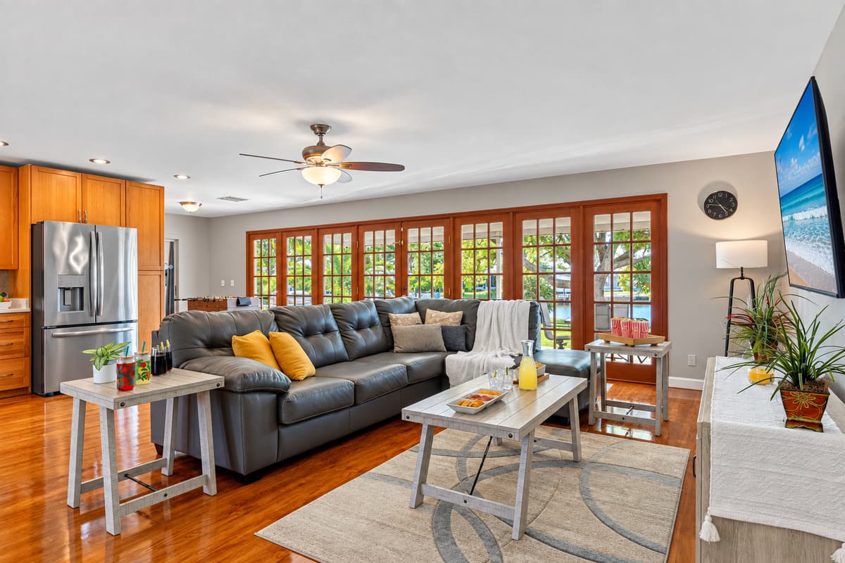 Featuring gleaming hardwood floors, a neutral color palette, and stylish furnishings, this living space balances modern design with homey comfort.