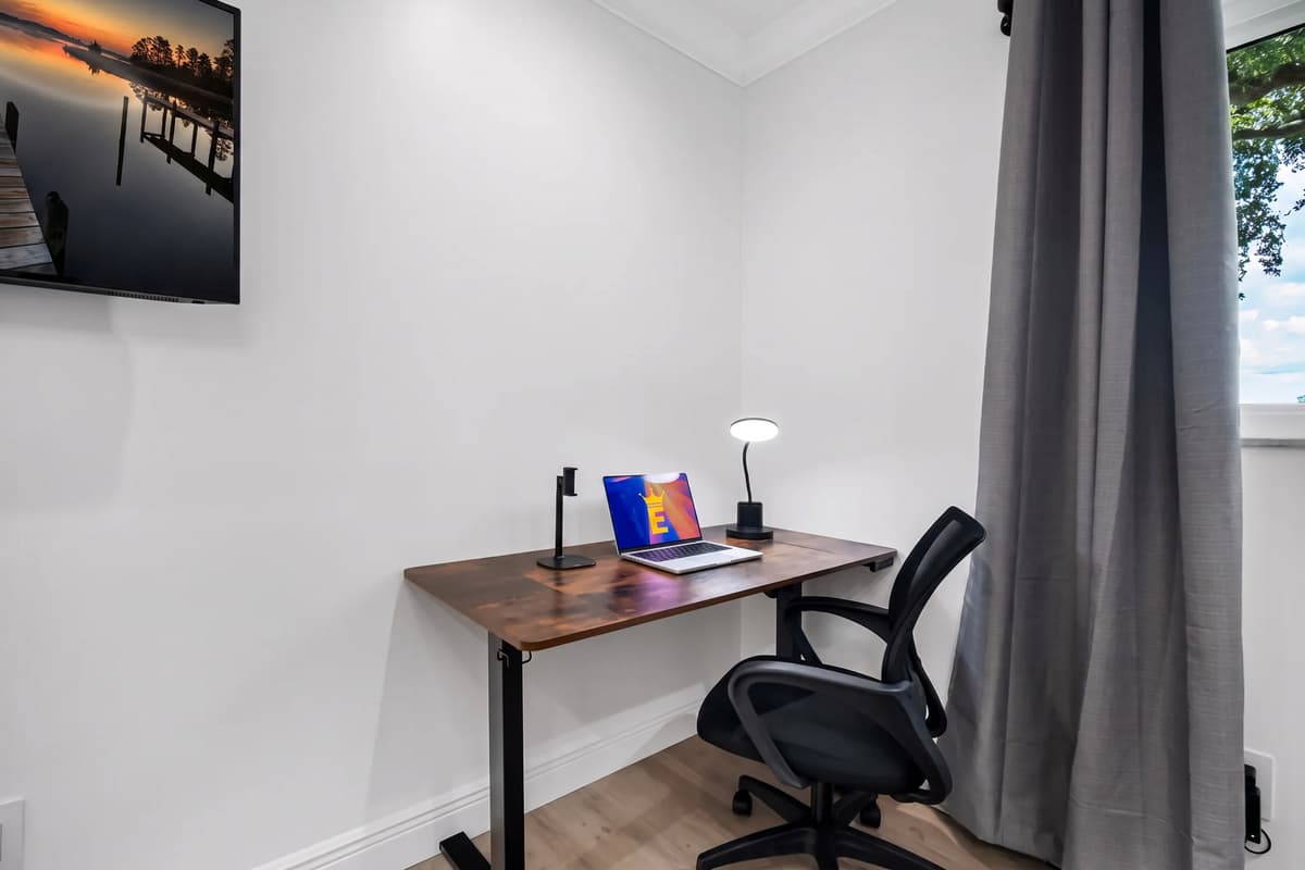 A dedicated workstation with an ergonomic chair makes this room perfect for digital nomads or remote professionals.