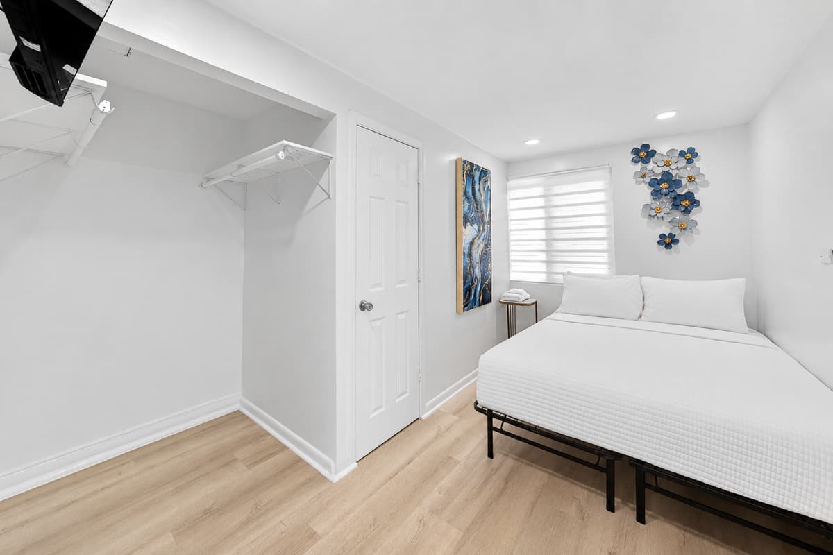 Private detached studio suite featuring a queen bed, modern furnishings, and additional privacy away from the main house.