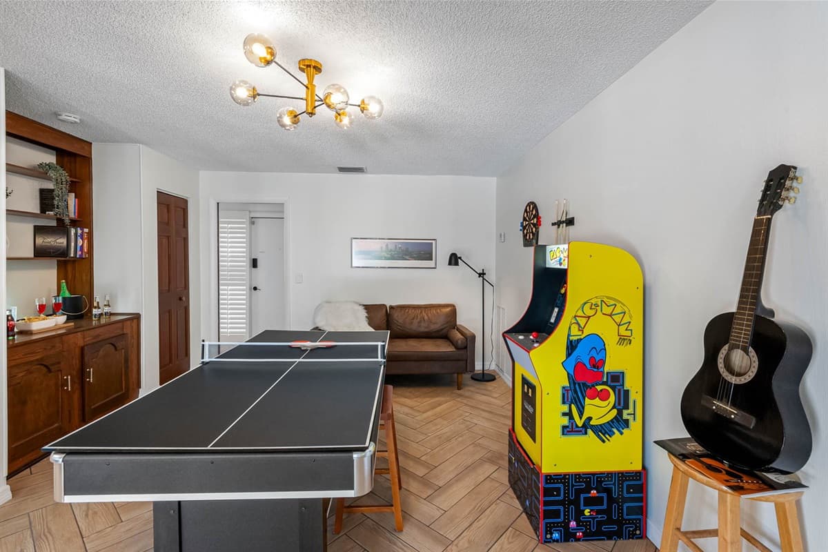 Designed with fun in mind, this game room offers a variety of ways to unwind—from competitive ping-pong matches to vintage arcade nostalgia and cozy, stylish seating.