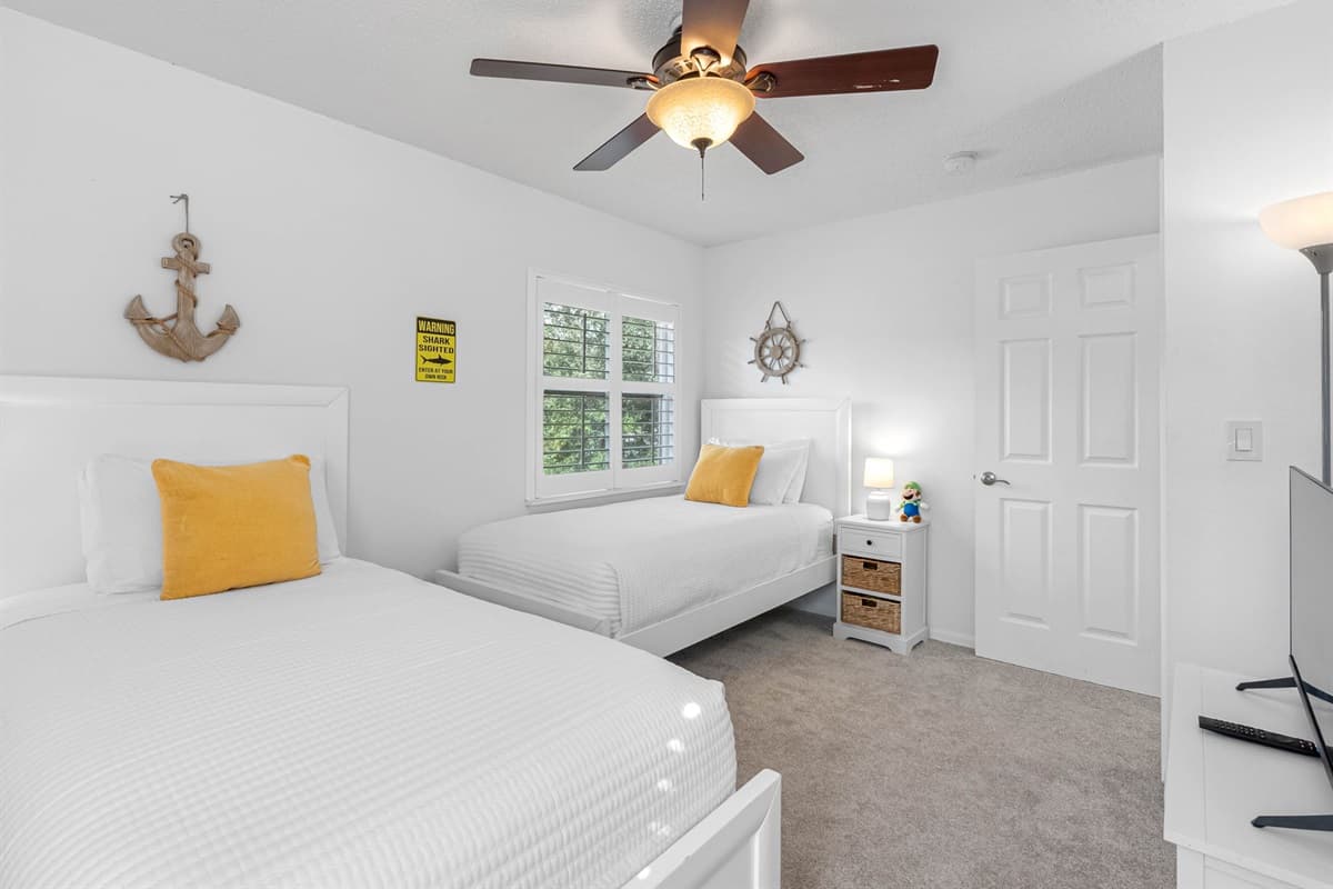 Fun and family-friendly room with two twin beds and playful shark-themed bedding.