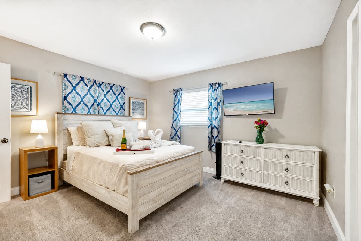 Draped in sumptuous linens, the bed beckons with promises of restful nights and lazy mornings.