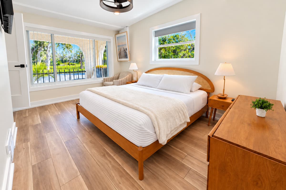 King bedroom with a woven wood headboard and coastal decor.