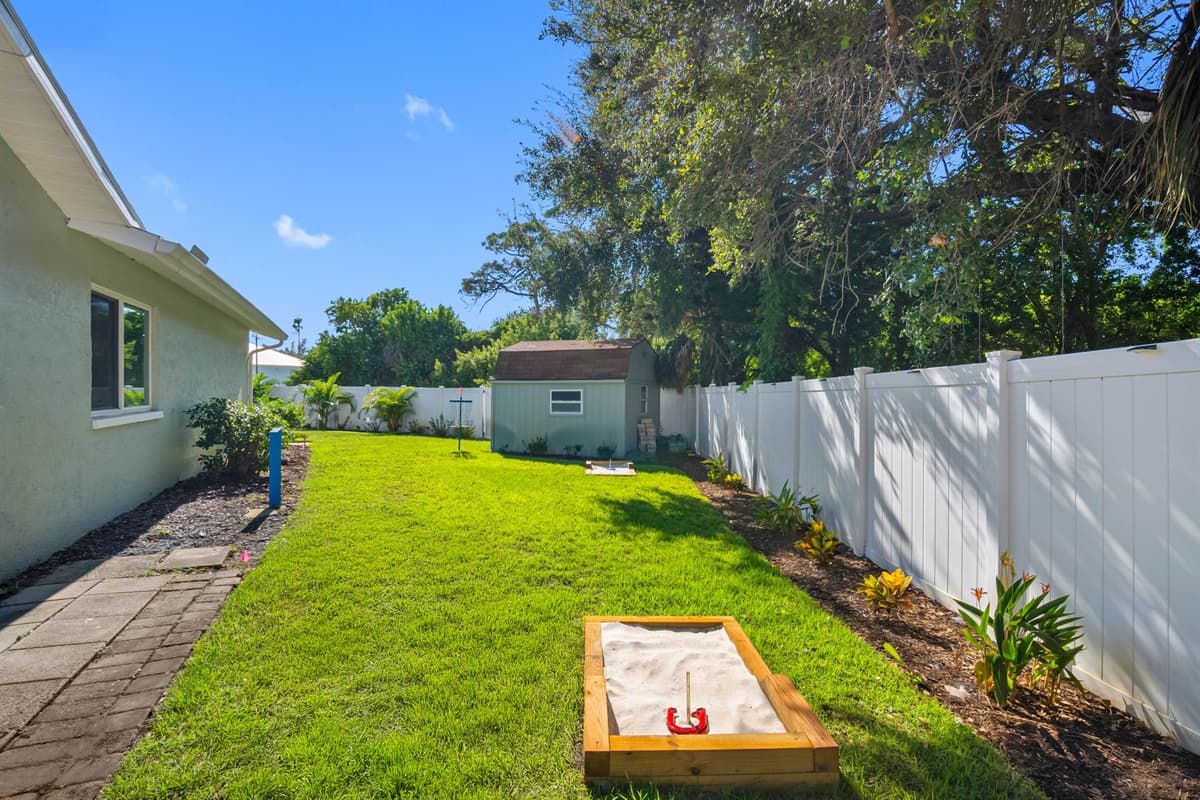 Practice your short game anytime with your very own putting green, nestled among lush palms in this beautifully maintained backyard.