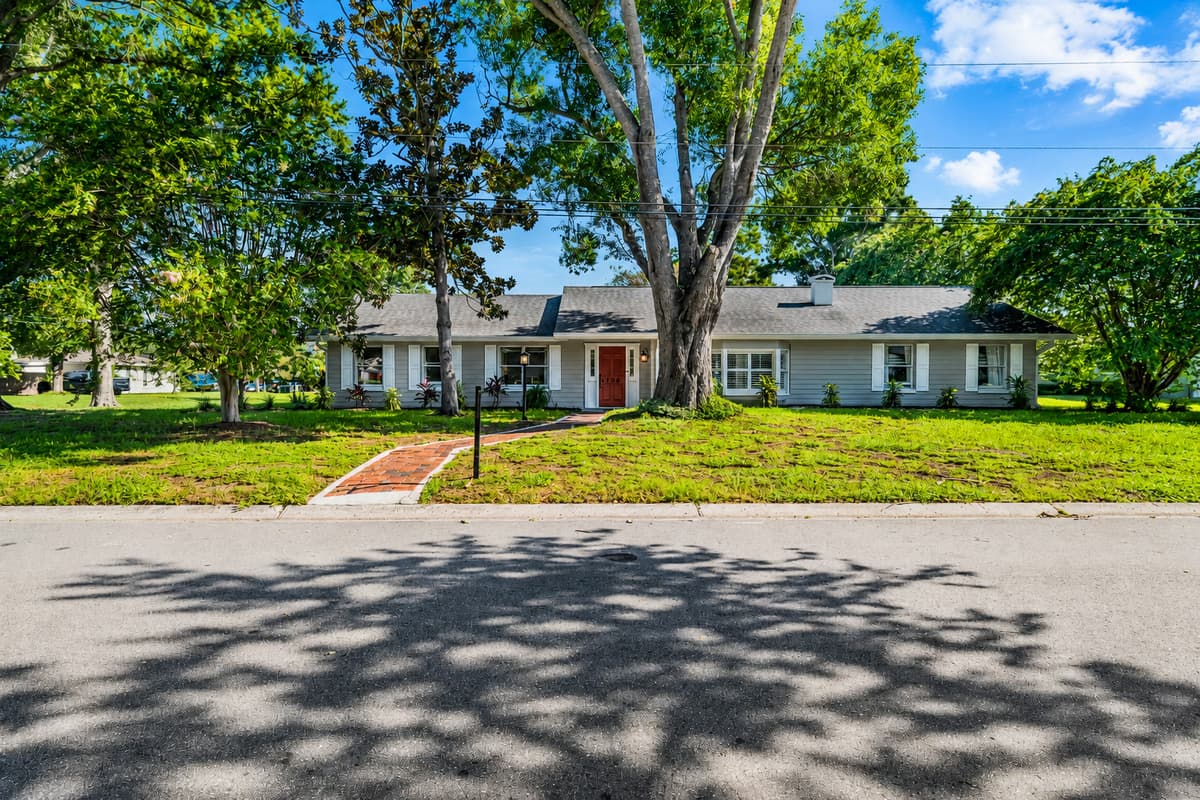 Long ranch house set back behind old oaks. Space between you and the street, and between you and everyone else.