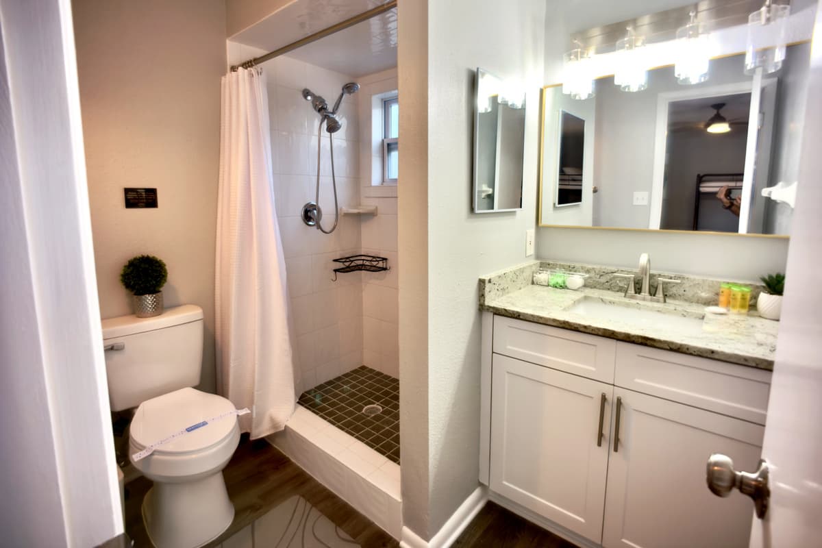 Designed for convenience, this bathroom includes a spacious walk-in shower for a refreshing experience.