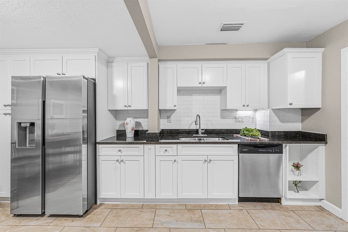 Modern kitchen featuring stainless steel appliances, sleek cabinetry, and ample counter space for cooking.