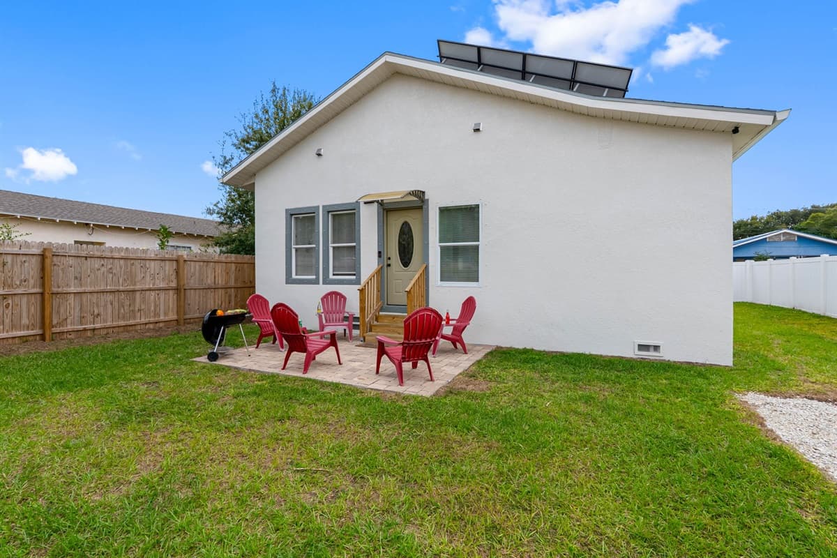 Surrounded by a fenced yard, the backyard seating area provides a peaceful and private spot to relax, soak up the sunshine, or enjoy a quiet evening outdoors.