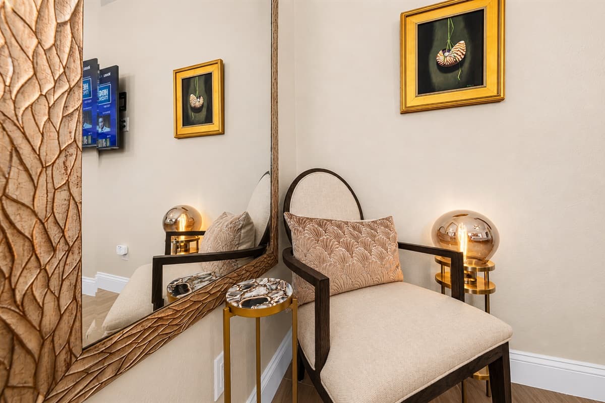 Charming bedroom seating nook with decorative accents — perfect for relaxing or getting ready for the day.