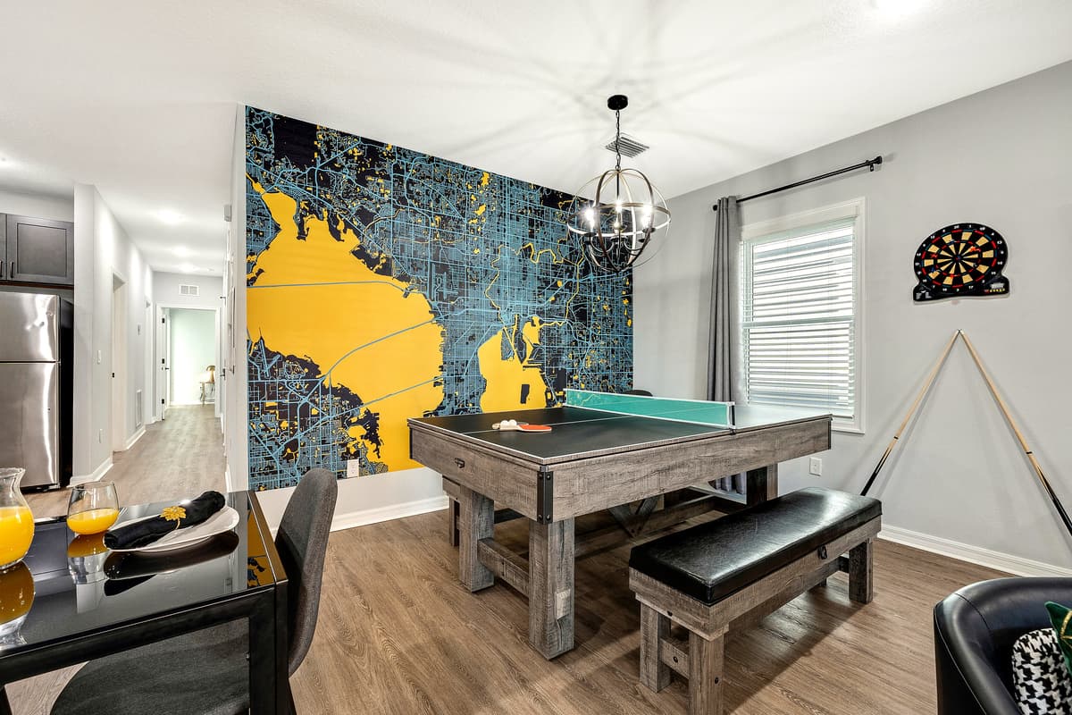 A vibrant space designed for entertainment and camaraderie, featuring a versatile convertible pool table and ping pong table.