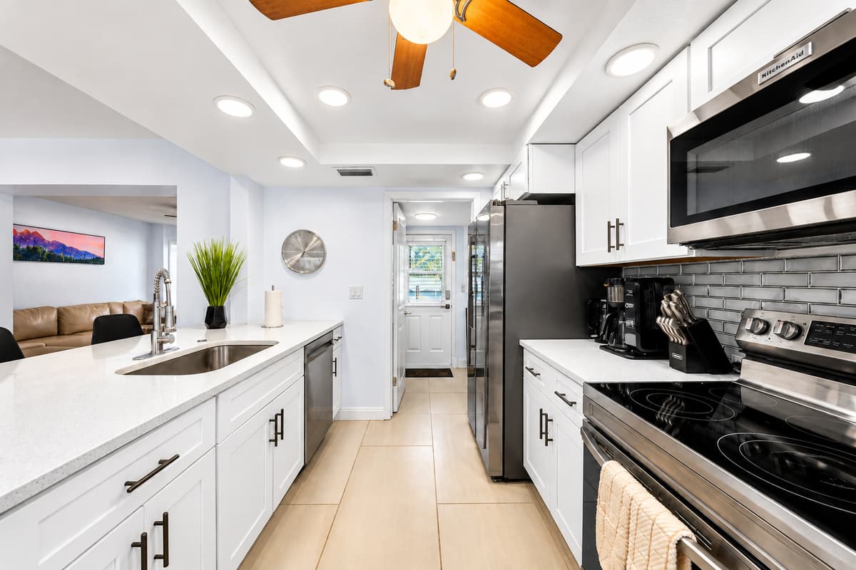 Sleek modern kitchen featuring stainless steel appliances, spacious countertops, and bright open layout.