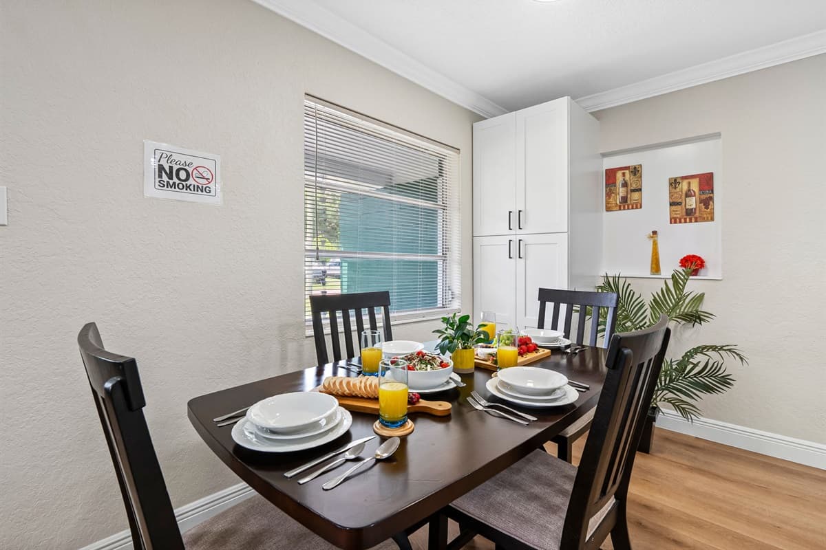 Gather, share, and savor meals in the welcoming dining area, thoughtfully positioned between the kitchen and living room for both convenience and connection.